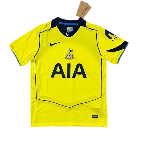 IVO yellow Tottenham Hotspur soccer jersey with navy accents, moisture-wicking fabric, and team crest.